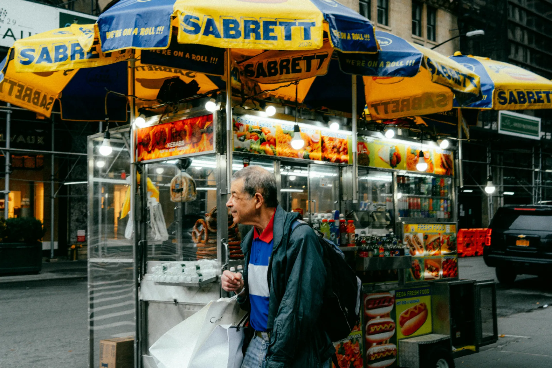 A man walks past a food cart in New York